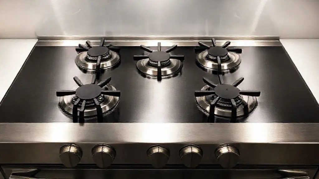 Fogão de 5 bocas moderno com mesa de vidro e acabamento em aço inox, destacando o design e a funcionalidade para cozinhas contemporâneas.